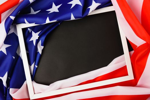 Martin luther king day, flat lay top view, American flag and photo frame on black background with copy space for your text