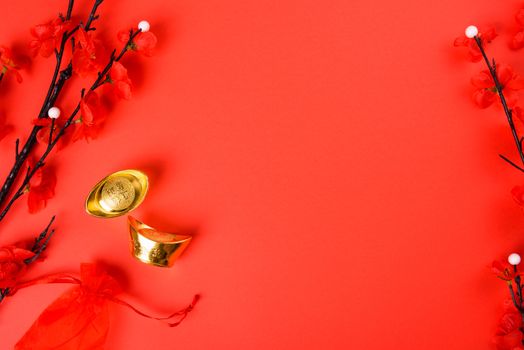 Chinese New Year, flat lay top view, gold bar and Chinese Flower on red background with copy space for your text