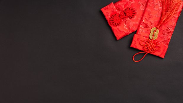 Chinese new year festival concept, flat lay top view, Happy Chinese new year with Red envelope (Character "FU" means fortune, blessing, wealth) on black background with copy space for your text