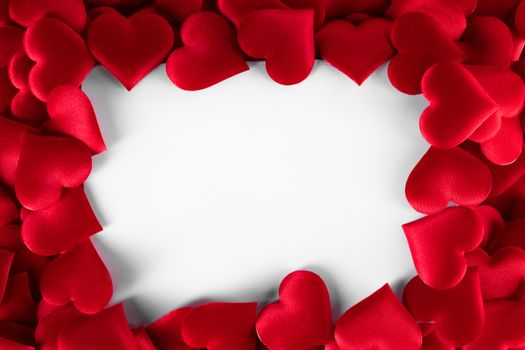 Valentine's day many red silk hearts background , border frame isolated on white with copy space, love concept