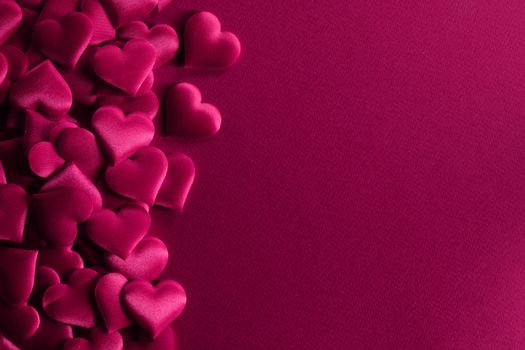 Valentine's day many red silk hearts background , border frame on red with copy space, love concept