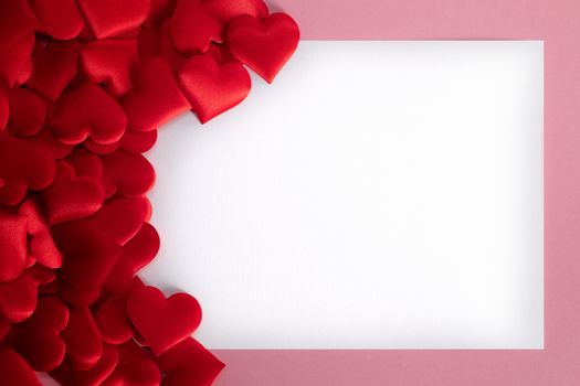 Valentine's day many red silk hearts background , border frame with white card with copy space, love concept