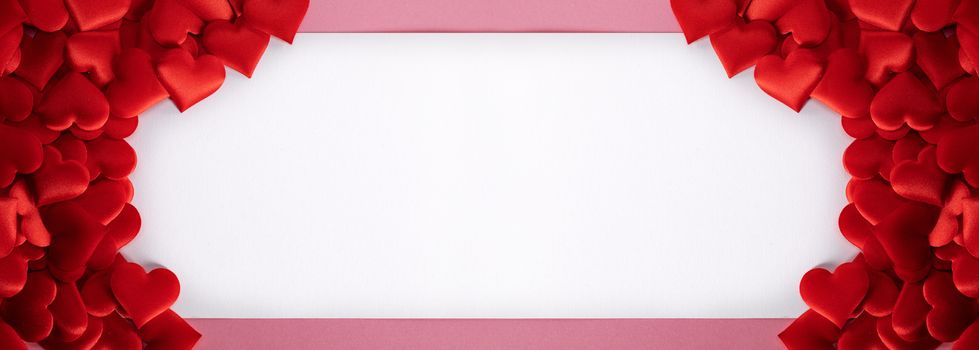Valentine's day many red silk hearts background , border frame with white card with copy space, love concept