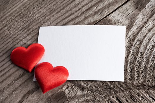 Valentine's day white blank paper greeting card and red silk hearts, background border frame with copy space, love concept