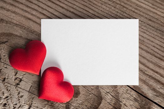 Valentine's day white blank paper greeting card and red silk hearts, background border frame with copy space, love concept