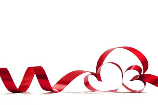 Heart shaped red ribbon isolated on white background