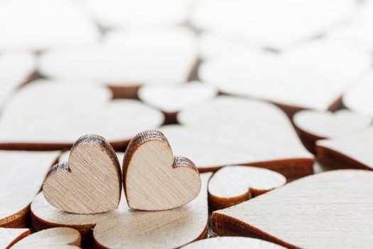 Many wooden colorless hearts background