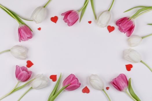 Frame made of colourful tulips and red hearts Valentines day background