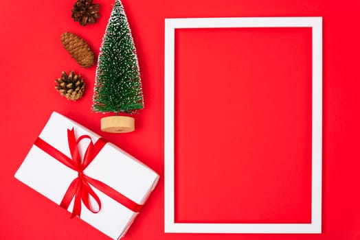 Happy New Year and Christmas 2020 day, top view Xmas white gift boxes & fir tree on red background with copy space for your text