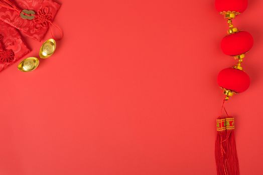 Chinese new year concept, flat lay top view, Happy Chinese new year with Red envelope and gold ingot (Character "FU" means fortune, blessing, wealth) on red background with copy space for your text