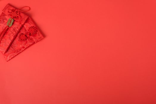 Chinese new year festival concept, flat lay top view, Happy Chinese new year with Red envelope (Character "FU" means fortune, blessing, wealth) on red background with copy space for your text