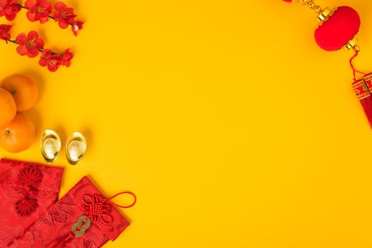 Chinese new year festival concept, flat lay top view, Happy Chinese new year with Red envelope and gold ingot (Character "FU" means fortune, blessing) on yellow background with copy space for text