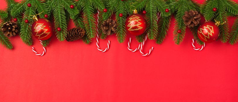 Happy new year or christmas day top view flat lay fir tree branches and decoration on red background with copy space for your text