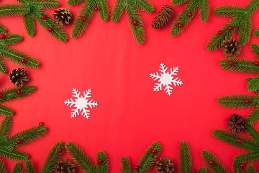 Happy new year or christmas day top view flat lay fir tree branches and decoration on red background with copy space for your text