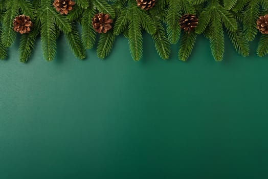 Happy new year, christmas day concept top view flat lay fir tree branches and decoration on Olive Green background with copy space for your text