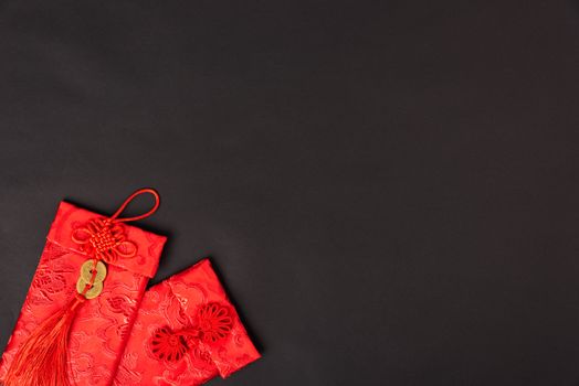 Chinese new year festival concept, flat lay top view, Happy Chinese new year with Red envelope (Character "FU" means fortune, blessing, wealth) on black background with copy space for your text