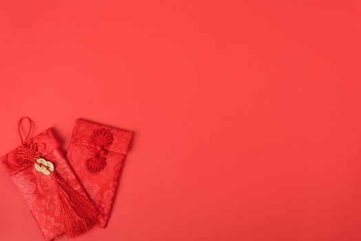 Chinese new year festival concept, flat lay top view, Happy Chinese new year with Red envelope (Character "FU" means fortune, blessing, wealth) on red background with copy space for your text