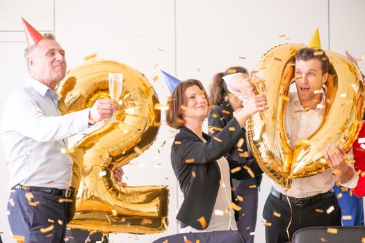 Business team of People Celebrating New Year in Modern Office. People Have Fun. Indoor Party. Celebrating of New Year.