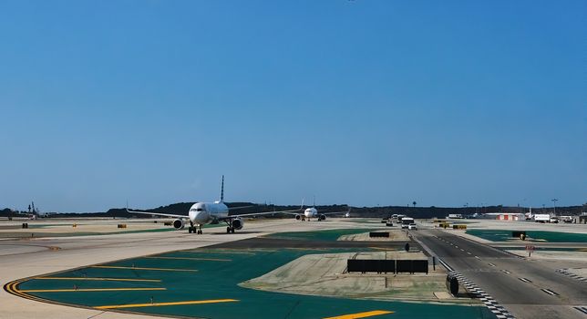 Planes Taxxing on Runway in a Commercial Airport