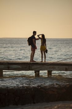 BAYAHIBE, DOMINICAN REPUBLIC 13 DECEMBER 2019: Young couple in love on the pier at susnset