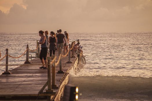 BAYAHIBE, DOMINICAN REPUBLIC 13 DECEMBER 2019: People on the pier at sunset