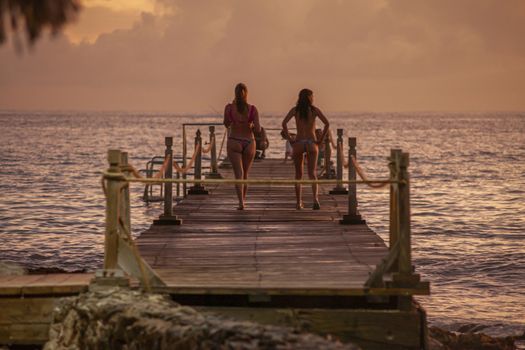 BAYAHIBE, DOMINICAN REPUBLIC 13 DECEMBER 2019: People on the pier at sunset