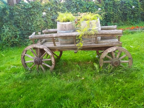
Ancient wooden cart with barrels.