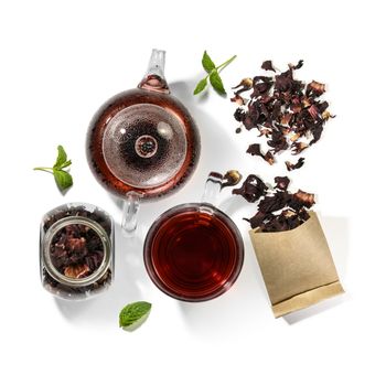 Hibiscus tea and beverage accessories on white background.