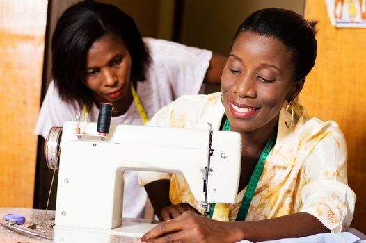 professional dressmaker is pleased to learn sewing to  her  student.