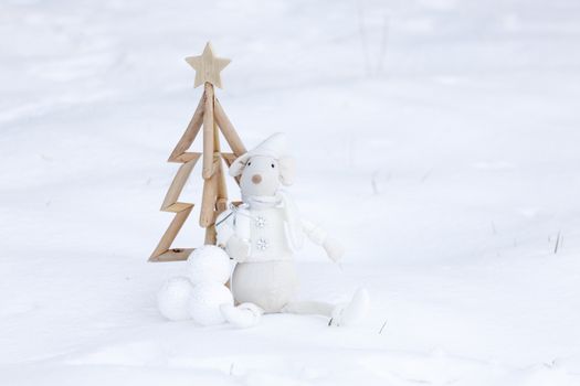 Simple Christmas tree, Christmas baubles and toy decoration carry present in fresh snow