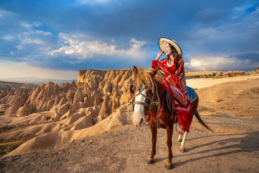 Tourists enjoy ride horses in Cappadocia, Turkey