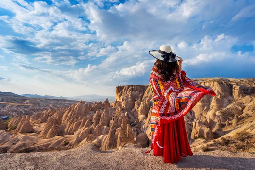 Woman standing on mountains in Cappadocia, Turkey.