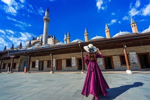 Beautiful girl walking at mosque in Konya, Turkey.