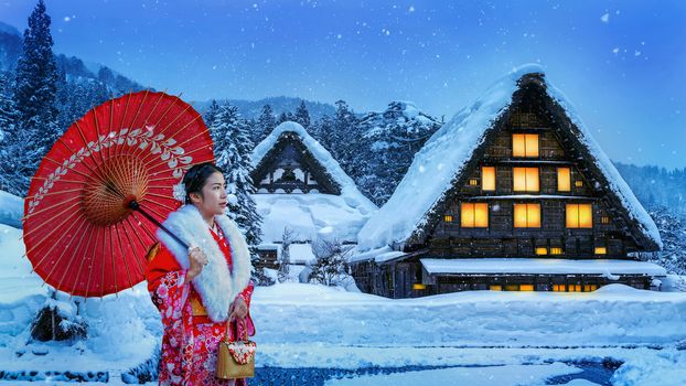 Asian woman wearing japanese traditional kimono at Shirakawa-go village in winter, UNESCO world heritage sites, Japan.