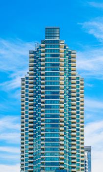 Modern Blue and White Condo Tower on Nice Sky