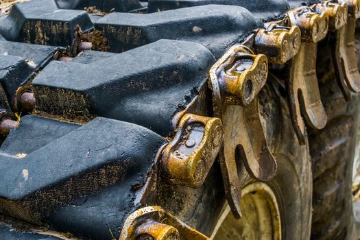 details of a caterpillar tire in closeup, construction equipment, earthmoving industry background