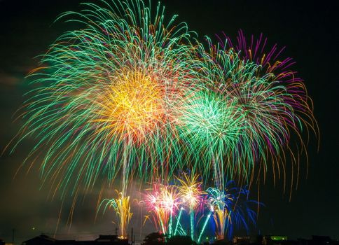 In images Colorful fireworks. Fireworks are a class of explosive pyrotechnic devices used for aesthetic and entertainment purposes. Visible noise due to low light, soft focus, shallow DOF, slight motion blur
