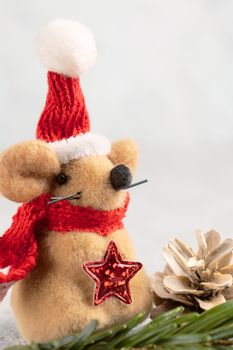 Little toy Christmas mouse and decorations on a gray table. Christmas composition with the symbol of 2020 according to the Chinese horoscope, horizontal banner with copy space.