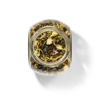 Green tea with aromatic additives. Top view on white background.
