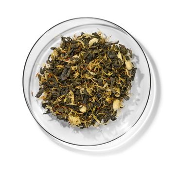 Green tea with aromatic additives. Top view on white background.