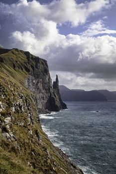 Trollkonufingur rock, also called The Witch's Finger on the island of Vagar. Trollkonufingur is a freestanding sea stack rock on the east of Sandavagur village on the Faroe Islands