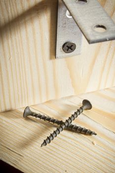 Metal corners and screws for fixing wooden boards