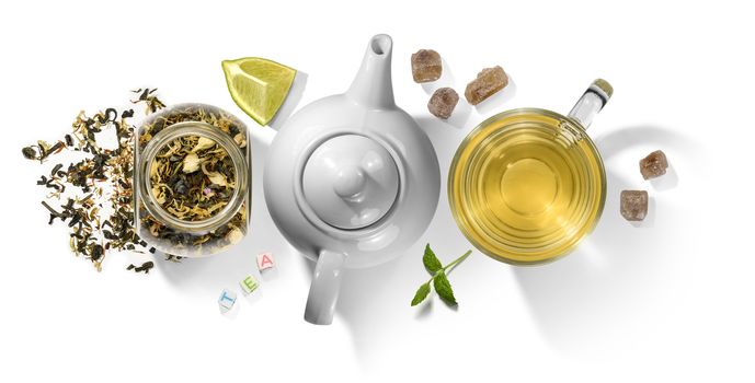 Green tea with aromatic additives and accessories. Top view on white background.