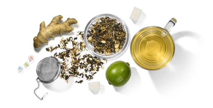 Green tea with aromatic additives and accessories. Top view on white background.