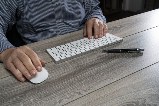 a man at work in front of a computer keyboard