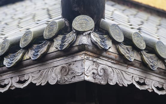 Close up of roof of Buddhist temple, Vietnam, with longevity symbols