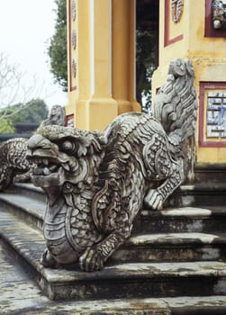Dragon-shaped handrail in Hue Imperial Palace, Vietnam. The symbol of good fortune on the wall