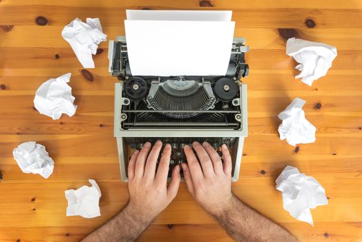 Writer's block. Typewriter and crumpled paper on work desk. Creative process concept