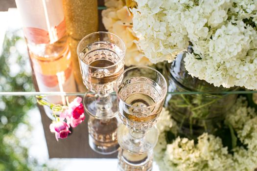 Rose blush wine in glasses. Bottle of rose wine with flowers on background. Prosecco.