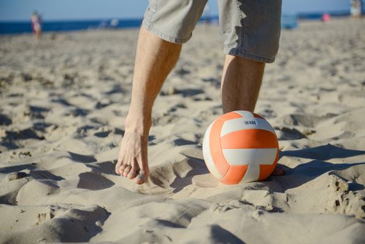 man playing soccer on beach with dribble skill and ball on vacation